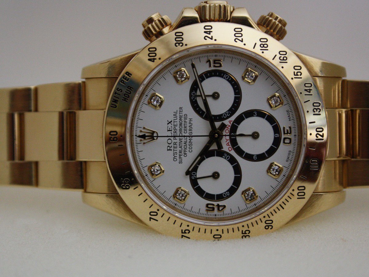 Yellow gold Zenith-era Rolex Daytona with white diamond dial and engraved gold bezel