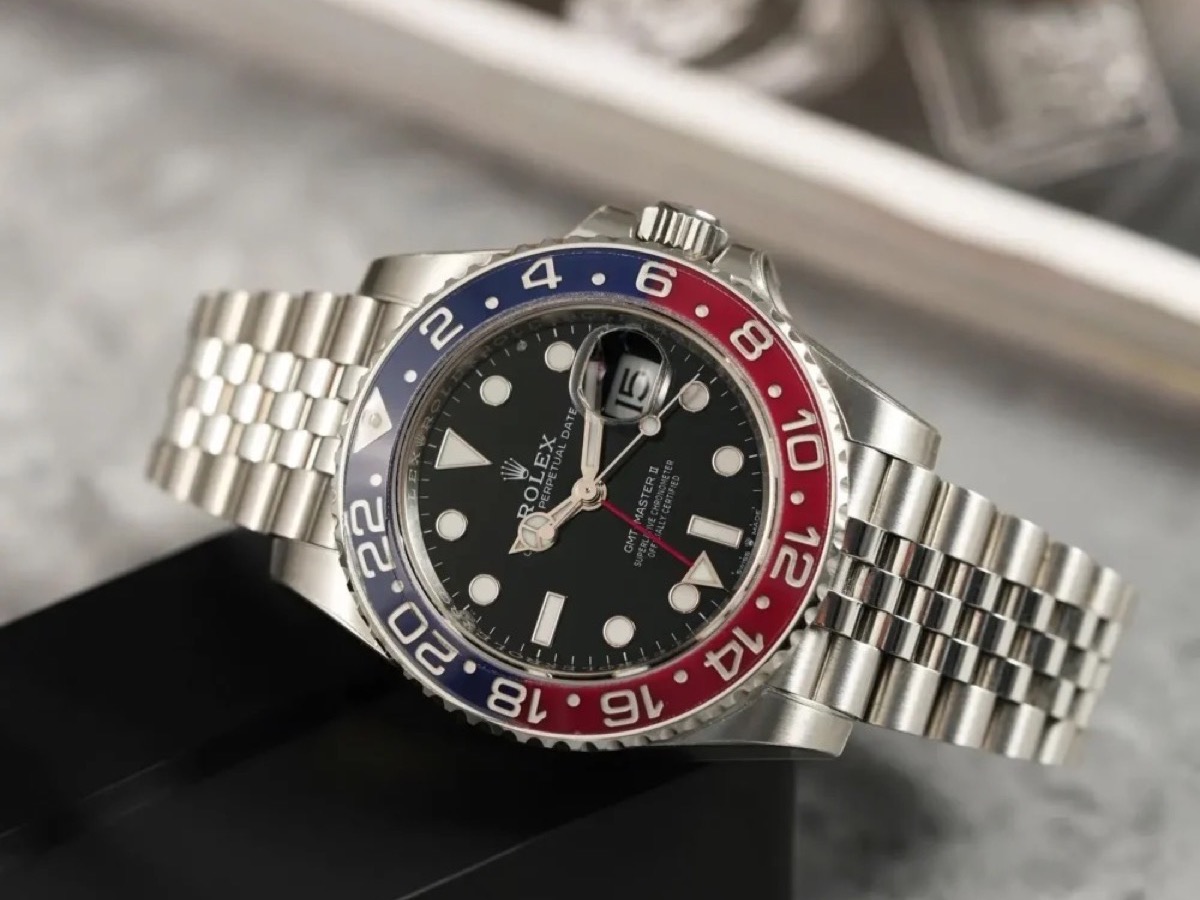Rolex GMT-Master II with Pepsi bezel and Jubilee bracelet, angled view over a watch box